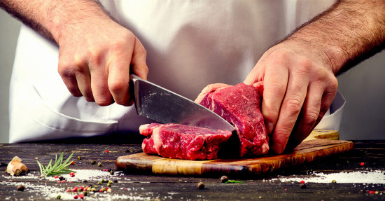 Man cutting beef meat